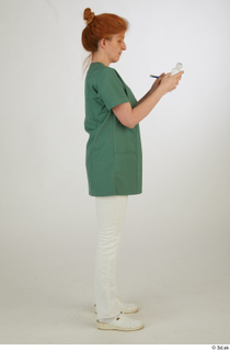  Photos Daya Jones Nurse in green Pose 2 preparing medication standing whole body 0007.jpg